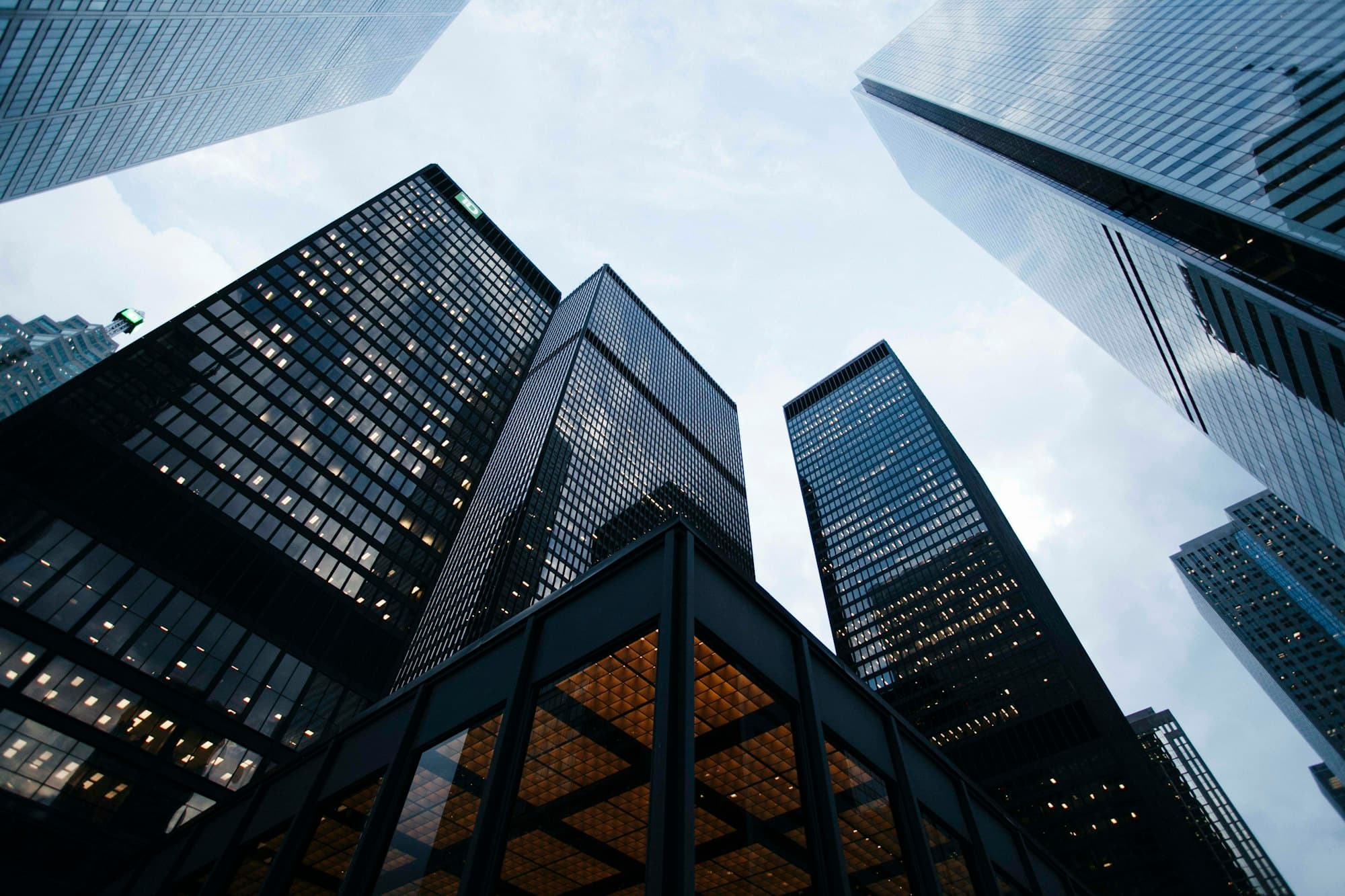 Glass office towers rising above a city street